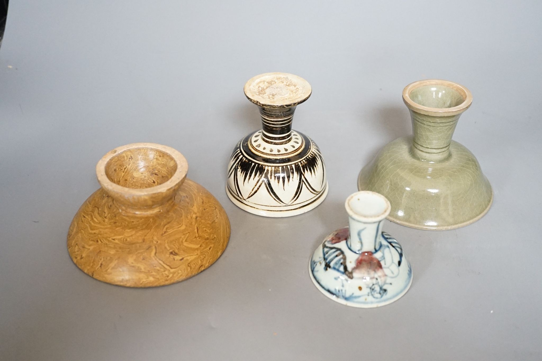Four various Chinese pottery or porcelain stem cups, tallest 10cm